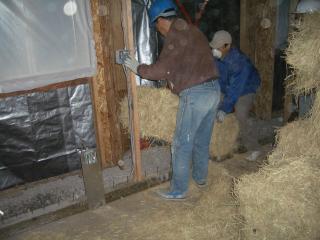 [Installing a first row of bales]